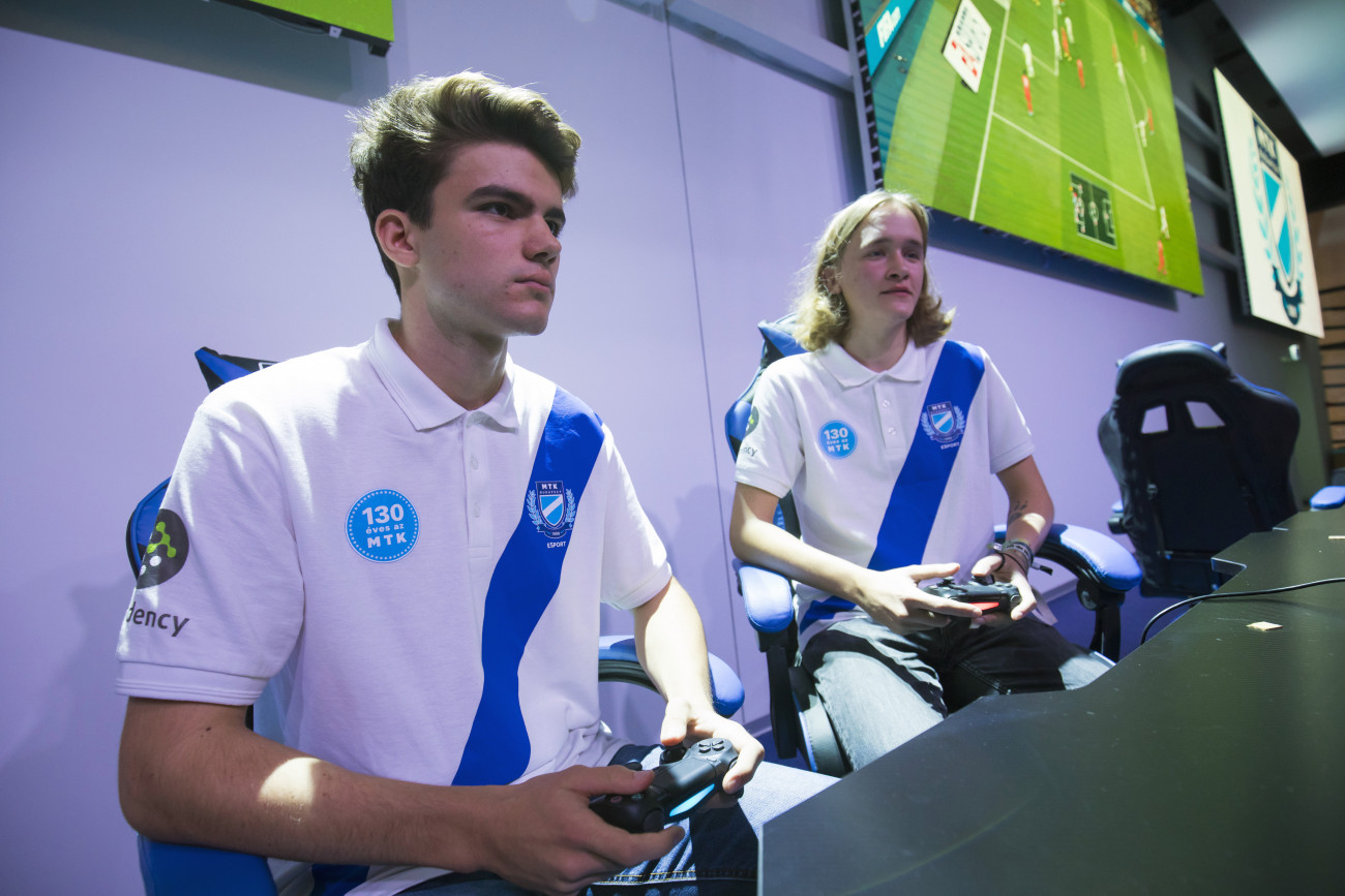 Budapest, 2019. szeptember 27.
Fehér Bálint és Rácz András, az MTK Budapest FIFA Pro Clubs csapatának tagjai (b-j) az MTK Esport Arénában, az Új Hidegkuti Nándor Stadionban 2019. szeptember 27-én. A sportág 2,1 millió euróból kialakított első magyarországi arénájában videojátékosok mérik össze ügyességüket, de ezen kívül különféle konferenciáknak és egyéb rendezvényeknek is otthon adhat a létesítmény.
MTI/Mohai Balázs