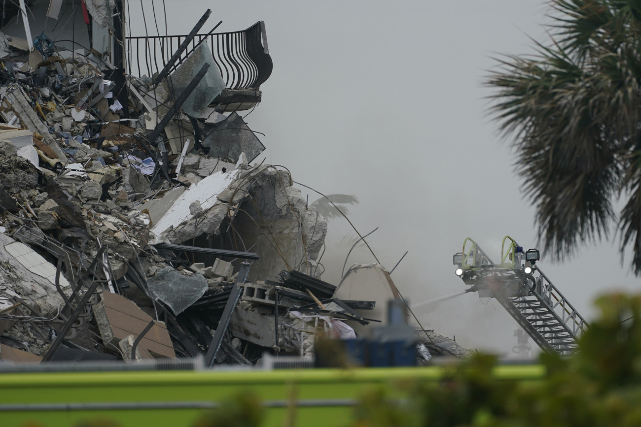 Surfside, 2021. június 24.
Füst gomolyog egy épület romjai közül a floridai Miami közelében fekvő Surfside-ban 2021. június 24-én, miután leomlott egy tizenegy emeletes lakóház egyik szárnya. Egy ember életét vesztette, ötvenegyet egyelőre keresnek a romok alatt.
MTI/AP/Wilfredo Lee