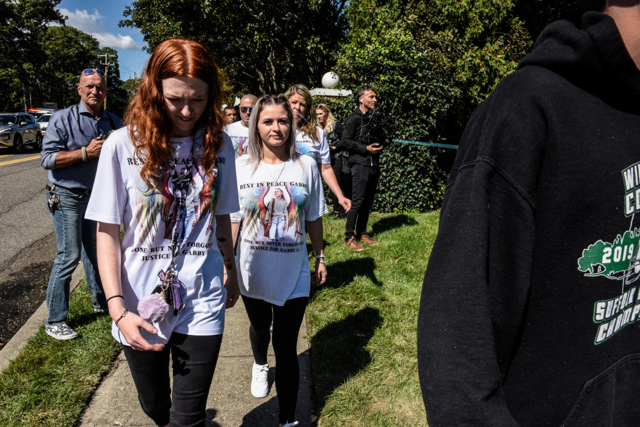 HOLBROOK, NY - SEPTEMBER 26: Mourners wearing t-shirts dedicated to Gabby Petito gather at a funeral home to pay respects to Gabby Petito on September 26, 2021 in Holbrook, New York. As the search continues into a second week in Florida to find Brian Laundrie, who is a person of interest, the family of Gabby Petito holds a public funeral in her hometown of Long Island. (Photo by Stephanie Keith/Getty Images)