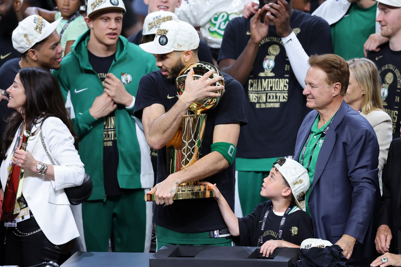 BOSTON, MASSACHUSETTS - JUNE 17: Jayson Tatum #0 of the Boston Celtics hugs the Larry OâBrien Championship Trophy after Boston's 106-88 win against the Dallas Mavericks in Game Five of the 2024 NBA Finals at TD Garden on June 17, 2024 in Boston, Massachusetts. NOTE TO USER: User expressly acknowledges and agrees that, by downloading and or using this photograph, User is consenting to the terms and conditions of the Getty Images License Agreement. (Photo by Adam Glanzman/Getty Images)