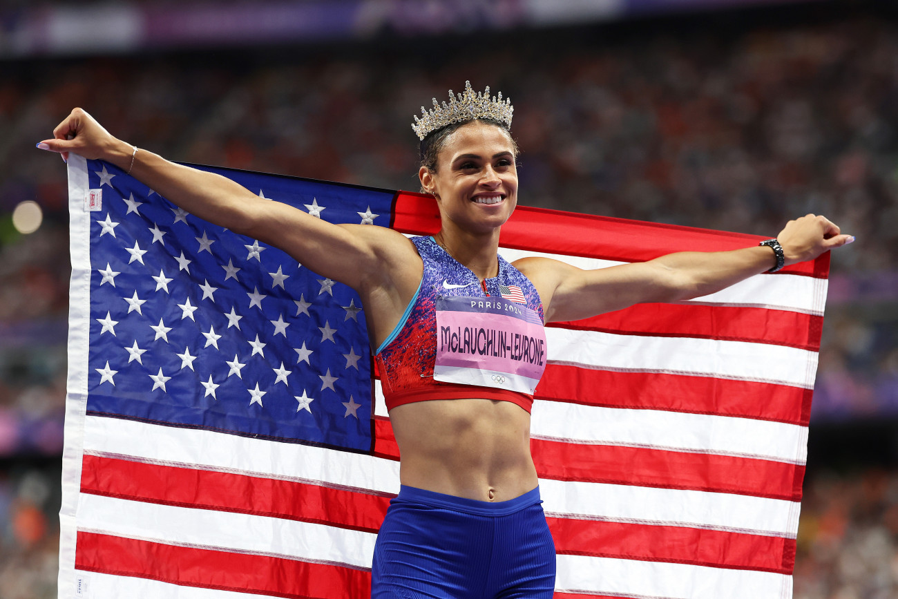 PARIS, FRANCE - AUGUST 08: Sydney McLaughlin-Levrone of Team United States celebrates winning the gold medal with the new World Record by wearing a crown after competing in the Women's 400m Hurdles Final on day thirteen of the Olympic Games Paris 2024 at Stade de France on August 08, 2024 in Paris, France. (Photo by Cameron Spencer/Getty Images)