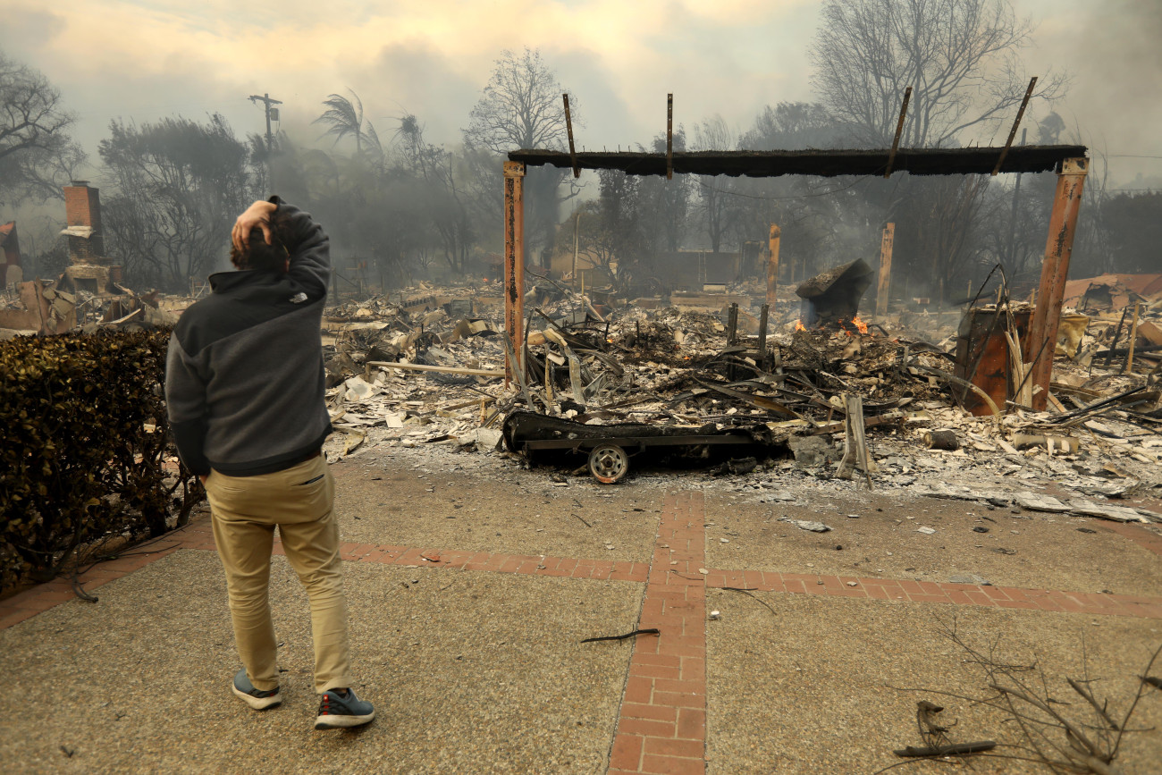 PACIFIC PALISADES, CA - JANUARY 8, 2025 - - Donald Bryce is devastated upon viewing the destruction of his father-in-law Stuart McCallister's home, destroyed in the Palisades fire on Haverford Avenue in Pacific Palisades on January 7, 2025. McCallister has lived in the home, he build, since 1996. He is a contractor who built many homes in the Palisades. 