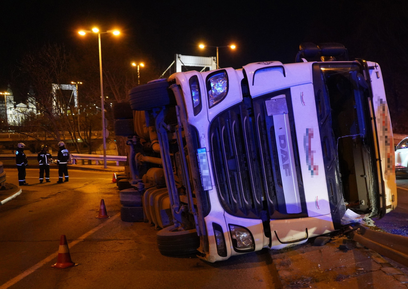 Budapest, 2025. március 3.
Oldalára borult, fát szállító teherautó a Hegyalja úton, a Krisztina körút közelében 2025. március 3-án.
MTI/Mihádák Zoltán