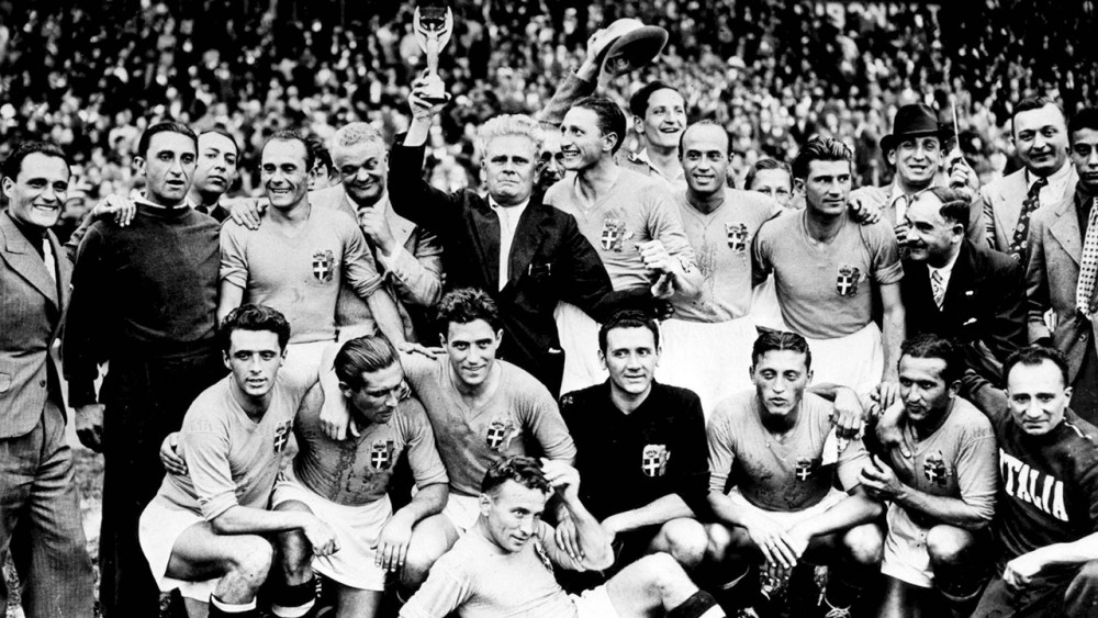 Italys soccer team coach Vittorio Pozzo, surrounded by his players, holds aloft the Jules Rimet Cup,after Italy won the World Cup Final, in Colombes Stadium, Paris, France, June 19, 1938. Italy defeated Hungary by four goals to two in the final. (AP Photo)