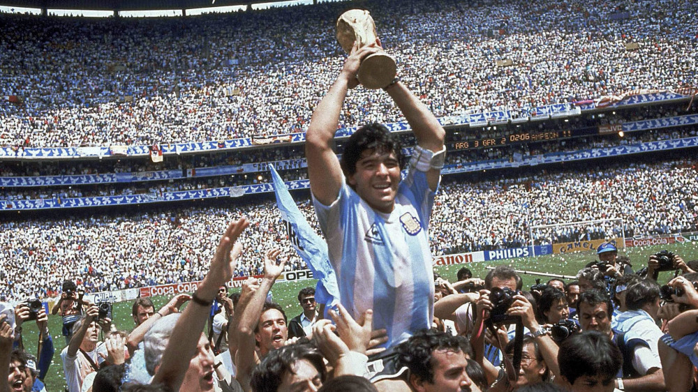** ADVANCE FOR WEEKEND EDITONS, MAY 29-30 **  FILE - In this June 29, 1986 file photo, Diego Maradona of Argentina, is lifted up as he holds the World Cup trophy after Argentina defeated West Germany 3-2 in the World Cup soccer final in the Atzeca Stadium, in Mexico City. (Ap Photo/Carlo Fumagalli, File)