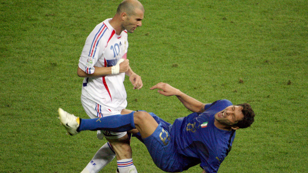 *** THE DECADE IN PICTURES *** A photo taken 09 July 2006 shows French midfielder Zinedine Zidane (L) gesturing after head-butting Italian defender Marco Materazzi during the World Cup 2006 final football match between Italy and France at Berlins Olympic Stadium.  AFP PHOTO  JOHN MACDOUGALL (Photo credit should read JOHN MACDOUGALL/AFP/Getty Images) ORG XMIT: DECADE-F