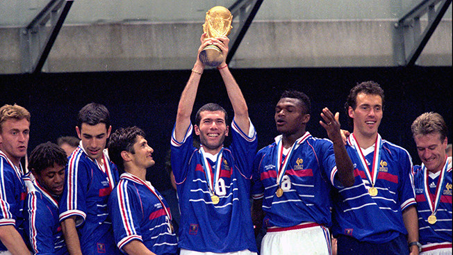 Frances Zinedine Zidane holds aloft the World Cup flanked by his teammates