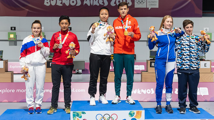 BUENOS AIRES - OCTOBER 11: (L-R) Silver medalist team Anastasiia DEREVIAGINA of the Russian Federation / Edson Ismael RAMIREZ RAMOS of Mexico, Gold medalist team Enkhmaa ERDENECHULUUN of Mongolia / Zalan PEKLER of Hungary and Bronze medalist team Viivi Natalia KEMPPI of Finland / Facundo FIRMAPAZ of Argentina pose with their medals after the 10m Air Rifle Mixed International Team Medal Matches at the Parque Sarmiento Shooting Range inside the Tecnopolis Park during Day 5 of the 3rd Youth Olympic Games on October 11, 2018 in Buenos Aires, Argentina. (Photo by Nicolo Zangirolami)