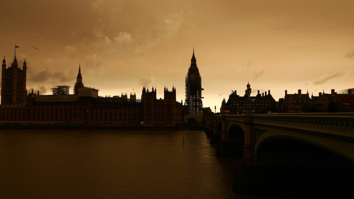 London, 2017. október 16.Sötét az ég a londoni Parlament és a Temze fölött 2017. október 16-án, miután az Ophelia hurrikán trópusi levegőt és szaharai homoktömeget sodort a brit főváros fölé. (MTI/EPA/Neil Hall)