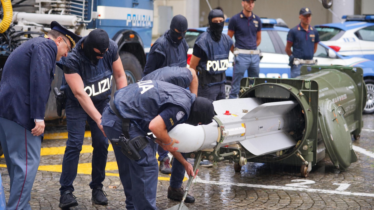Az olasz rendőrség terrorelhárító különítménye lefoglalt levegő-levegő rakétát vizsgál Torinóban 2019. július 15-én. Az olasz hatóságok a nap folyamán több északolasz városban tartottak rajtaütést, amelyeken hadifegyvereket foglaltak le szélsőjobboldali csoportoktól, és három embert őrizetbe vettek.