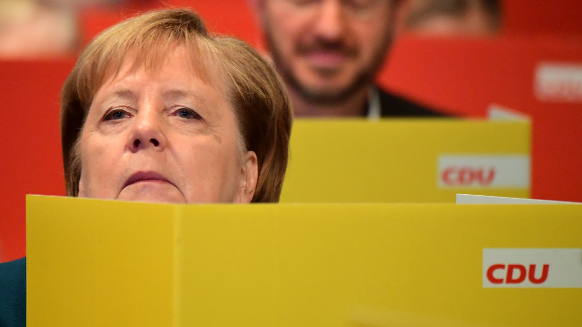 Angela Merkel német kancellár, a kormányzó Kereszténydemokrata Unió (CDU) korábbi elnöke (k) küldöttek között a párt kétnapos lipcsei kongresszusa második napi ülésének egyik szavazásán 2019. november 23-án.