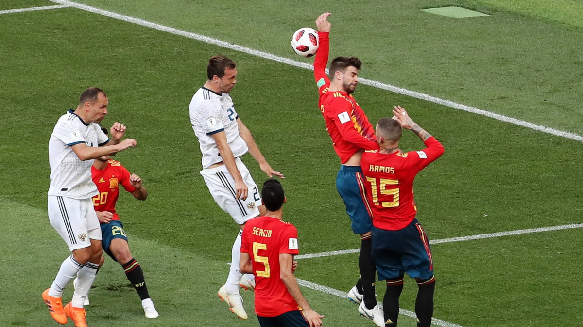 Moszkva, 2018. július 1.A spanyol Gerard Piqué felemelt kezéről visszapattan az orosz Artyom Dzjuba (k) fejese a 16-oson belül, és ezért a játékvezető 11-est ítél az oroszországi labdarúgó-világbajnokság nyolcaddöntőjének Spanyolország  Oroszország mérkőzésén a moszkvai Luzsnyiki Stadionban 2018. július 1-jén. (MTI/EPA/Abedin Taherkenareh)