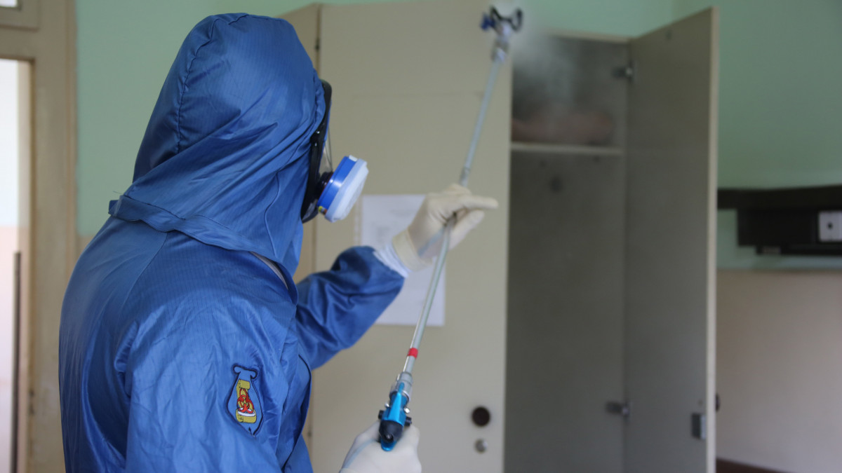 Az orosz védelmi minisztérium sajtószolgálata által 2020. április 13-án közreadott képen egy orosz katonai járványügyi szakember a koronavírus-járvány miatt fertőtlenítést végez egy katonai kórházban a szerbiai Nisben 2020. április 12-én.