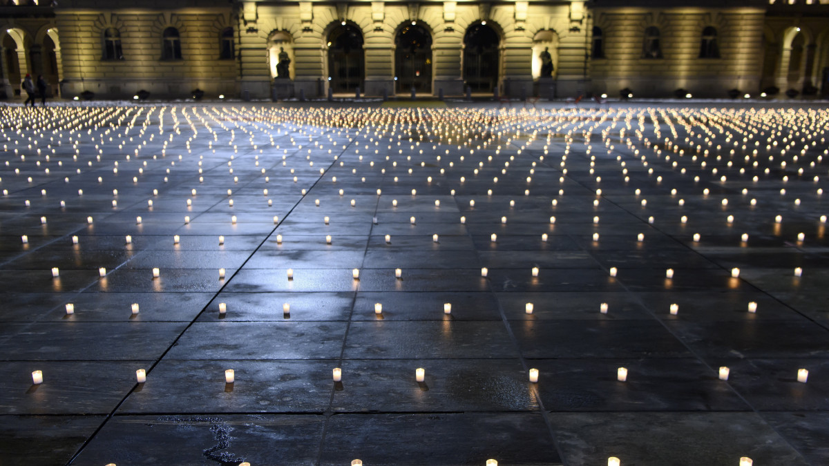 A koronavírus-járvány következtében elhunytak emlékére gyújtott mintegy ötezer mécses világít a berni parlament előtt 2020. december 6-án.