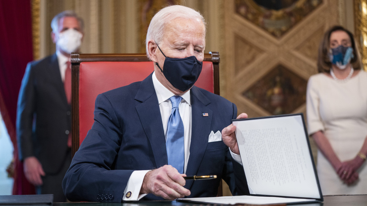 Joe Biden amerikai elnök aláírja a beiktatási, valamint a kormányzati tisztségekre jelölt személyek jelöléséről szóló dokumentumokat a törvényhozás washingtoni épületében, a Capitolium elnöki irodájában 2021. január 20-án, beiktatása napján.