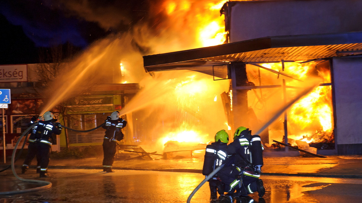 Tűzoltók dolgoznak egy kigyulladt szentendrei áruház oltásán a Dunanyar körúton 2021. április 7-én. A tűz az áruház raktárában keletkezett.