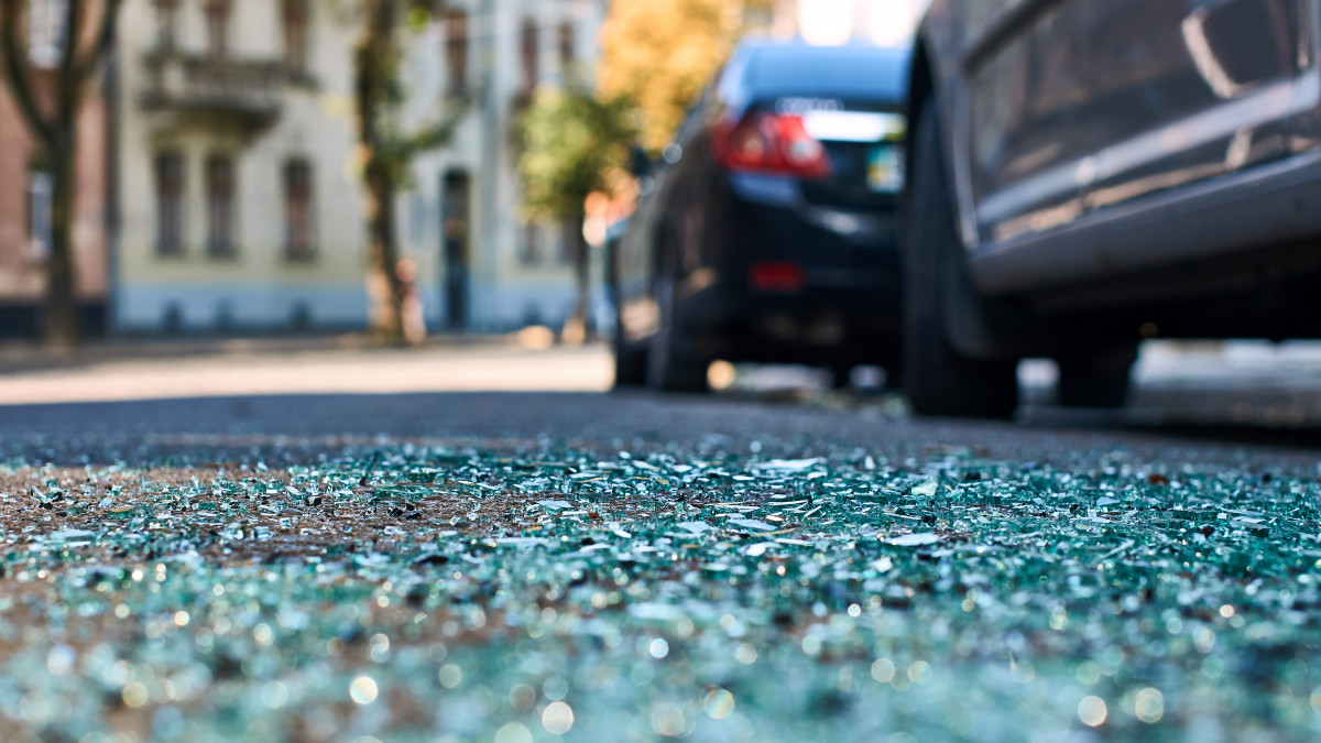 Sharp shards of car glass on the asphalt