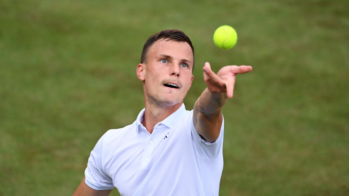 LONDON, ENGLAND - JUNE 28: Marton Fucsovics of Hungary serves in his Mens Singles First Round match against Jannik Sinner of Italy during Day One of The Championships - Wimbledon 2021 at All England Lawn Tennis and Croquet Club on June 28, 2021 in London, England. (Photo by Mike Hewitt/Getty Images)
