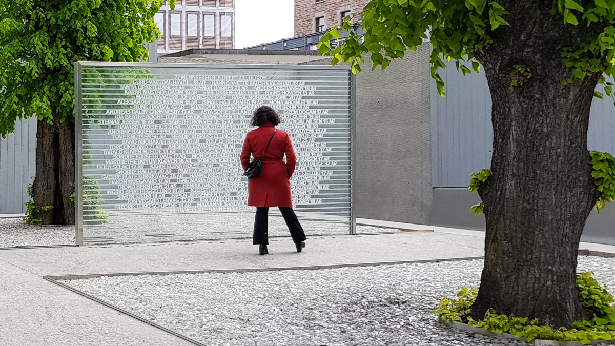 FILED - 09 July 2021, Norway, Oslo: Kamzy Gunaratnam, deputy mayor of Oslo who survived the attack on UtĂ¸ya, stands next to a monument in the government district with the names of the 77 people killed in the two attacks carried out by Norwegian terrorist Anders Behring Breivik. It has been 10 years since Breivik killed a total of 77 people in Oslo and on the island of UtĂ¸ya. The police have learned from their mistakes, but society is only now beginning to come to terms with them. (to dpa Never again July 22 - Norways response to terror) Photo: Sigrid Harms/dpa (Photo by Sigrid Harms/picture alliance via Getty Images)