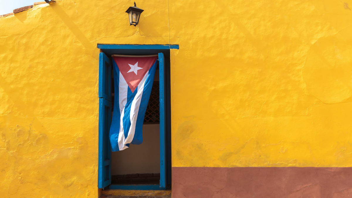 Cuban flag hanging on a door in Trinidad, Cuba