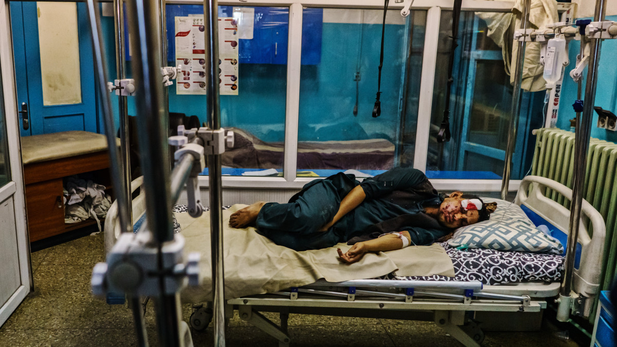 KABUL, AFGHANISTAN -- AUGUST 26, 2021: A wounded patient lays in the recovery unit at Wazir Akbar Khan Hospital. in Kabul, Afghanistan, Thursday, Aug. 26, 2021.  Twin bombings struck near the entrance to KabulĂs airport Thursday, ripping through crowds of Afghans and foreign nationals waiting for evacuation from the country. The explosions complicated an already-nightmarish airlift just before the U.S. deadline to remove its troops from the country. (MARCUS YAM / LOS ANGELES TIMES)