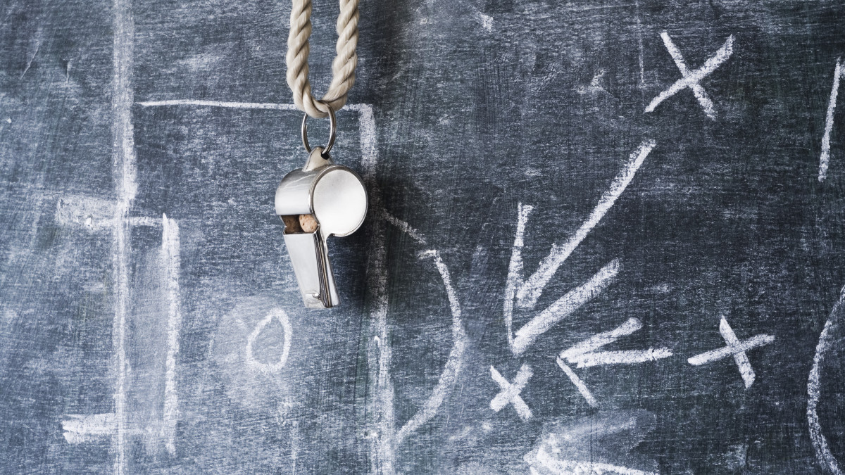 whistle of a soccer / football referee or coach on black board with tactical diagram