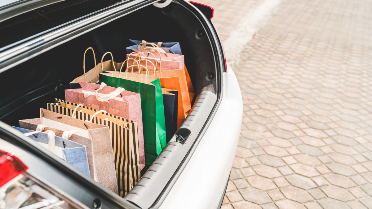 Shopping bags in car trunk with copy space. Modern shopping lifestyle, rish people or leisure activity concept