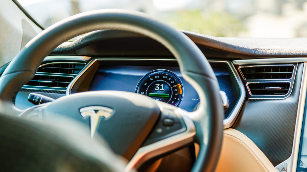 Los Angeles, United States - May 17, 2013: A cockpit with LCD digital speedometer and steering wheel of electric car Tesla Model S during drive. Tesla electric cars are produced by Tesla Motors, Inc. in California, USA.