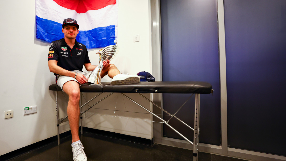 ABU DHABI, UNITED ARAB EMIRATES - DECEMBER 12: Race winner and 2021 F1 World Drivers Champion Max Verstappen of Netherlands and Red Bull Racing celebrates with his trophy after the F1 Grand Prix of Abu Dhabi at Yas Marina Circuit on December 12, 2021 in Abu Dhabi, United Arab Emirates. (Photo by Mark Thompson/Getty Images)