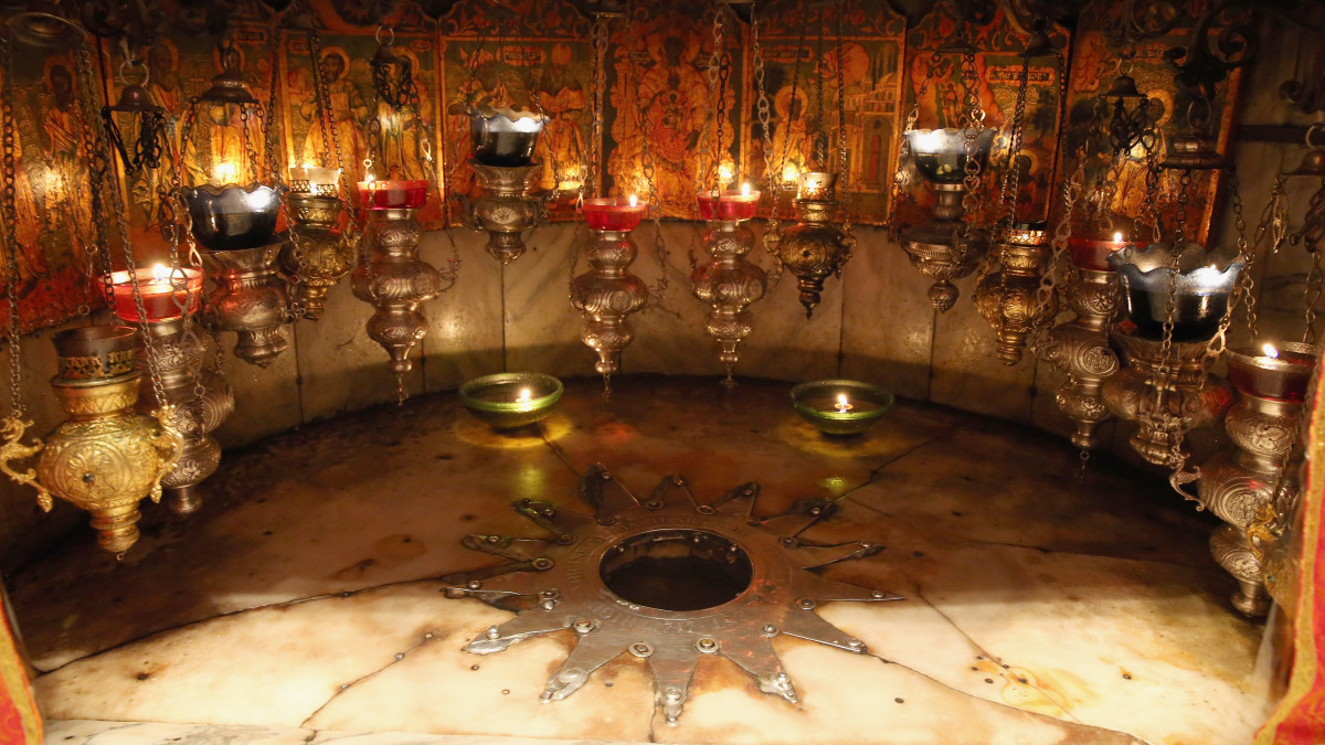 BETHLEHEM, WEST BANK - JUNE 16:  This fourteen-point silver star, beneath the altar in the Grotto of the Nativity, marks the traditional spot believed to be the birth place of Jesus Christ in the Church of the Nativity on June 16, 2013 in central West Bank. Located in the Palestinian territories, the church was originally commissioned in 327 AD, in Bethlehem.  (Photo by Ian Walton/Getty Images)