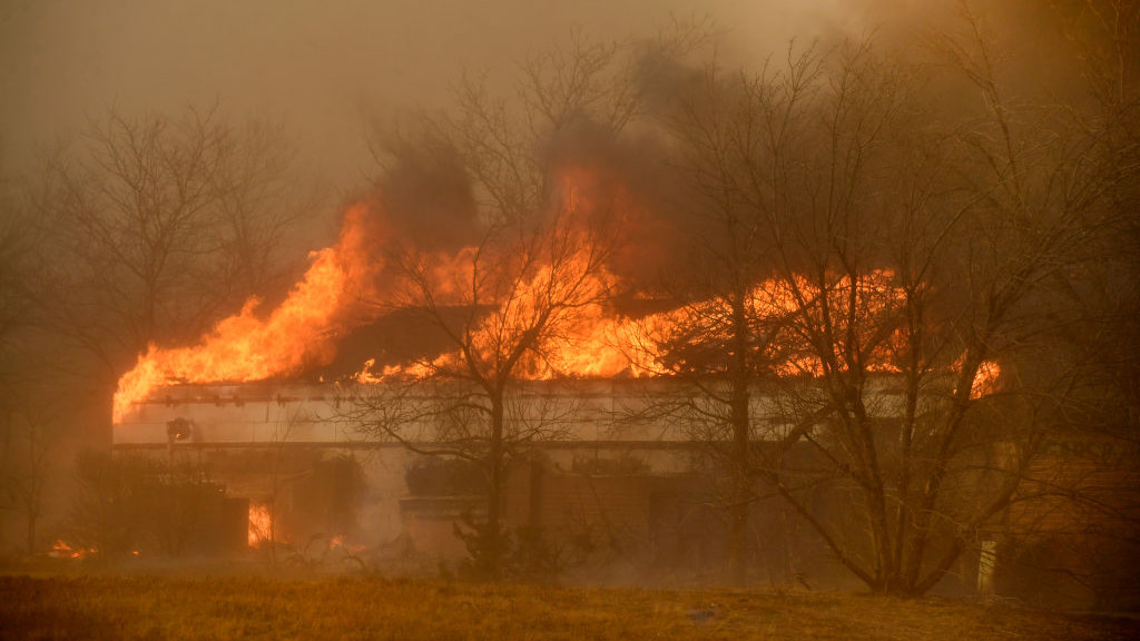 LOUISVILLE, CO - DECEMBER 30: Fire takes over a business along McCaslin Blvd on December 30, 2021 in Louisville, Colorado. Fierce winds have whipped wildfires in Boulder County. The towns of Superior and Louisville have been evacuated. Multiple homes and businesses have burned from the fast moving fire stocked by fierce winds, with gusts topping 100 mph, along the foothills. The fire has officially been named the Marshall Fire. (Photo by Helen H. Richardson/MediaNews Group/The Denver Post via Getty Images)