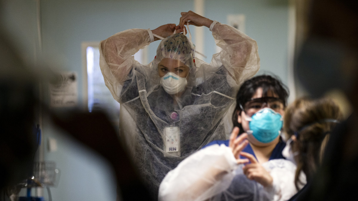 Védőfelszerelést vesznek fel nővérek, mielőtt az új koronavírus okozta Covid-19-ben szenvedő betegek szobáiba mennek a kaliforniai San Diegótól nyugatra fekvő Coronado Sharp Coronado Kórházának intenzív osztályán 2021. január 20-án.