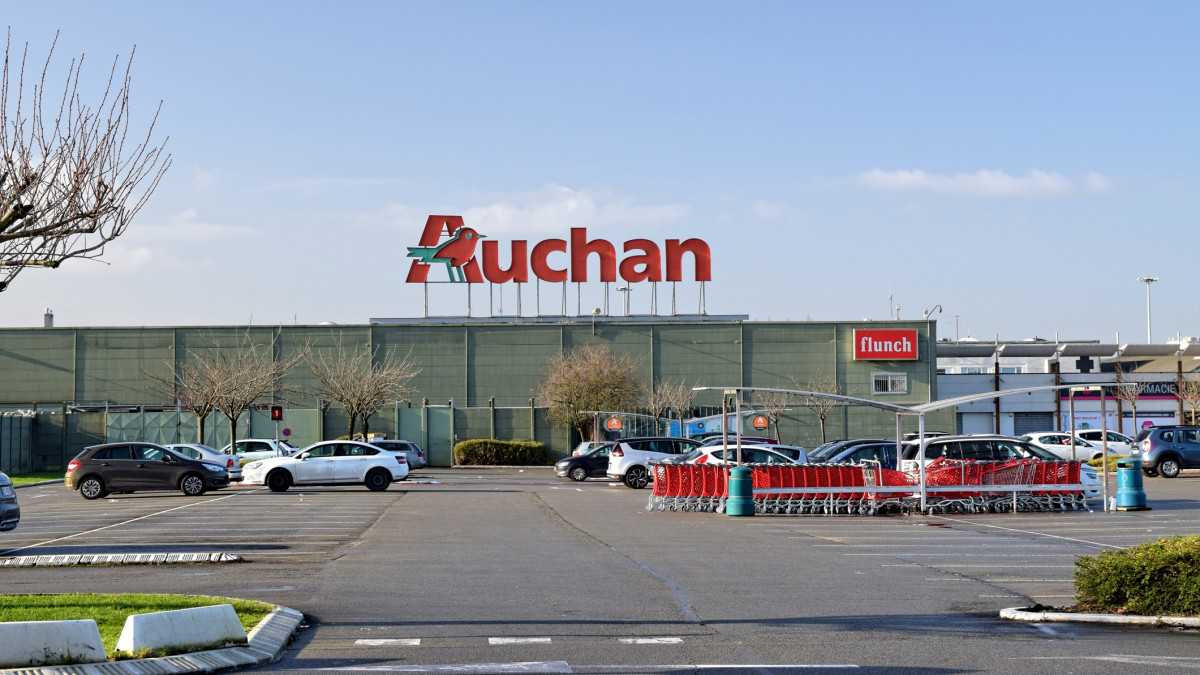 Leers,FRANCE-January 19,2020: View of Auchan supermarket logo and parking.Auchan is a French international supermarket chain, is one of the largest distribution groups in the world.
