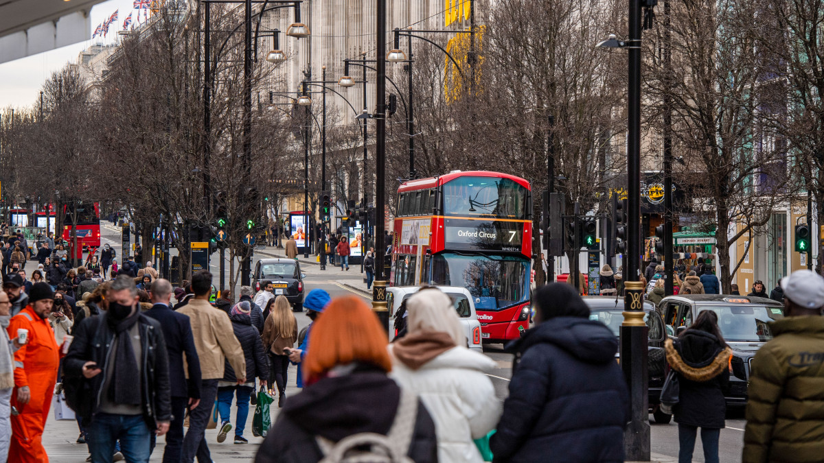 Shoppers make their way along Oxford Street in central London, U.K., on Thursday, Jan. 20, 2022. The U.K. Office for National Statistics are due to release their latest retail figures on Friday. Photographer: Chris J. Ratcliffe/Bloomberg via Getty Images