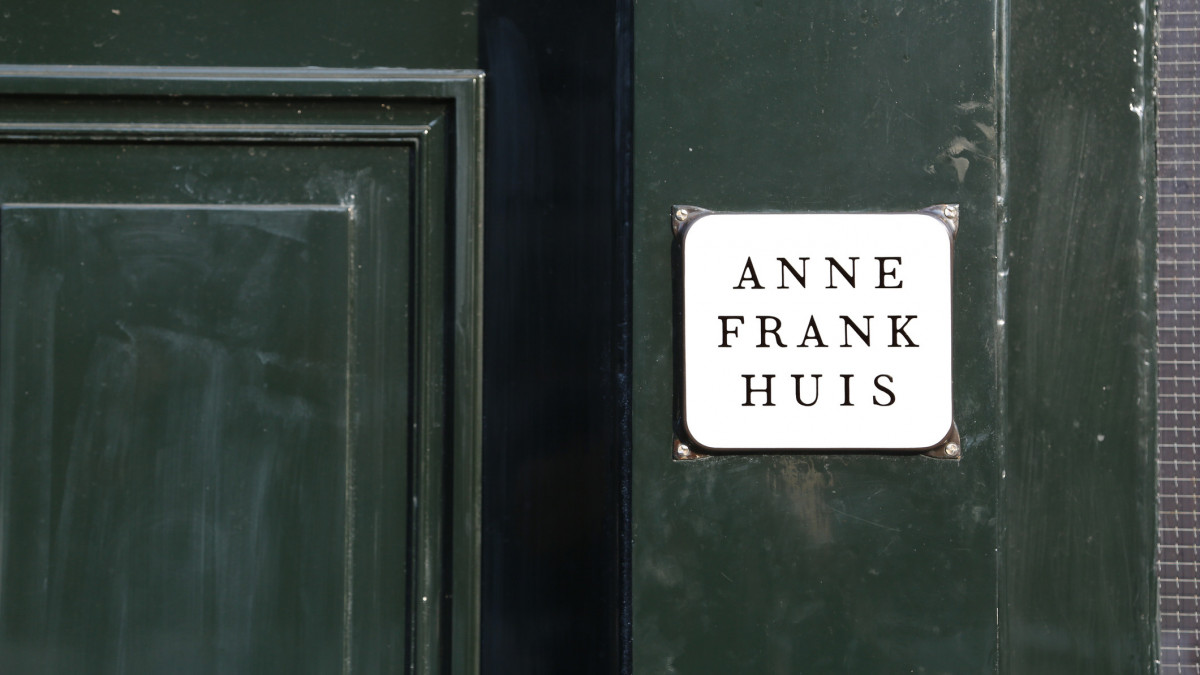 Amsterdam, Netherlands - August 22, 2017: entrance of the house of the Jewish young girl ANNE FRANK with the text on the green door that means Anne Frank House in Dutch Language
