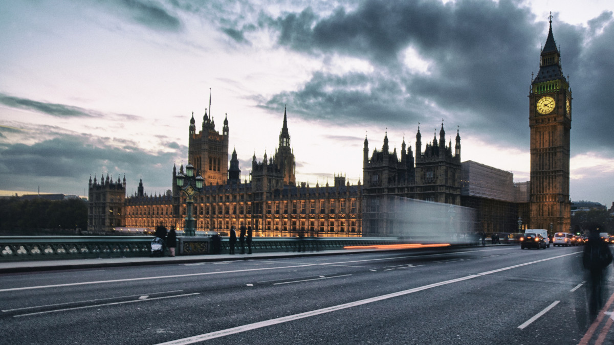 Traffic streams past the Palace of Westminster on a Winters evening.