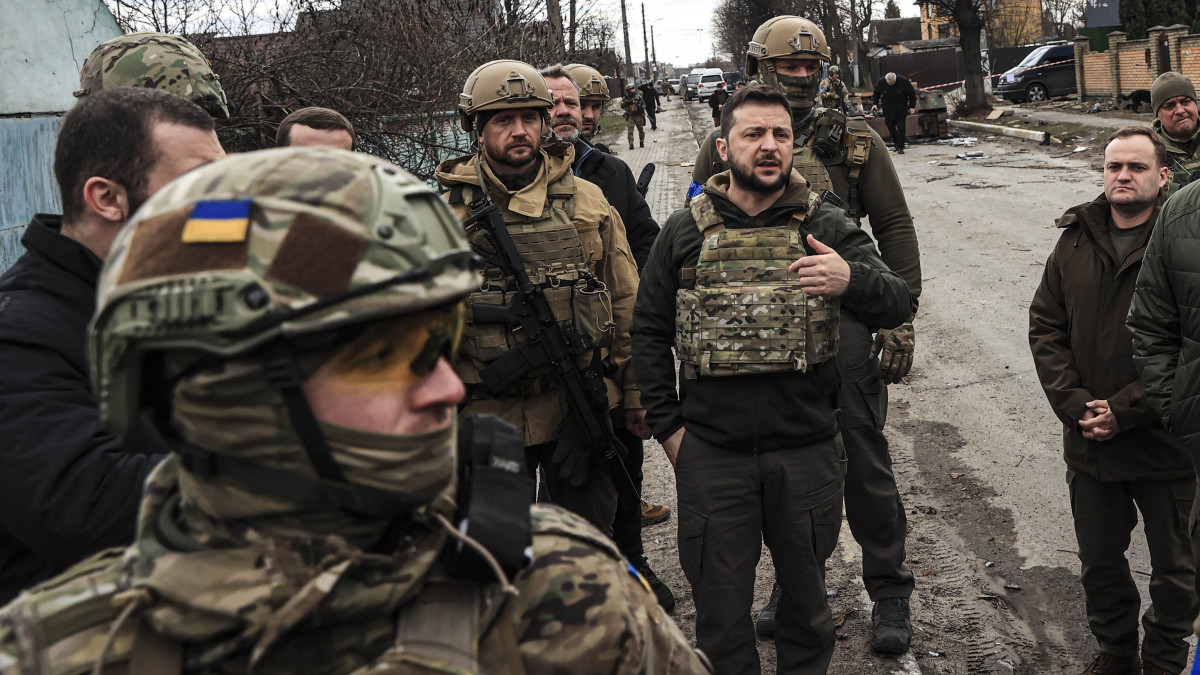 BUCHA, KYIV PROVINCE, UKRAINE, APRIL 04: Ukrainian President Volodymyr Zelenskyy accompanied by Ukrainian soldiers visits the town of Bucha, after it was liberated from Russian Army, in Bucha, Ukraine on April 04, 2022. (Photo by Metin Aktas/Anadolu Agency via Getty Images)