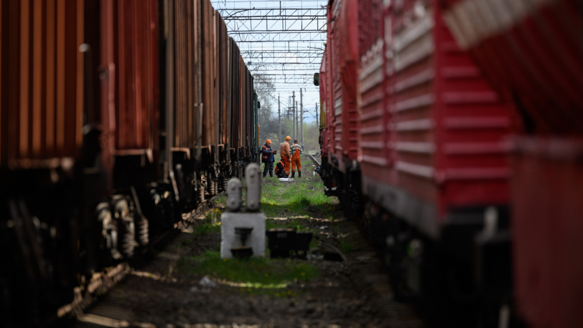 LVIV, UKRAINE - APRIL 25: Rail workers wait between two train lines, near to the site of a missile strike on April 25, 2022 near Lviv, Ukraine. The head of Ukrainian Railways said in a social media post today that five rail facilities had been attacked by Russia this morning, including a traction substation, a facility supplying power to overhead lines, in Krasne, near Lviv. (Photo by Leon Neal/Getty Images)