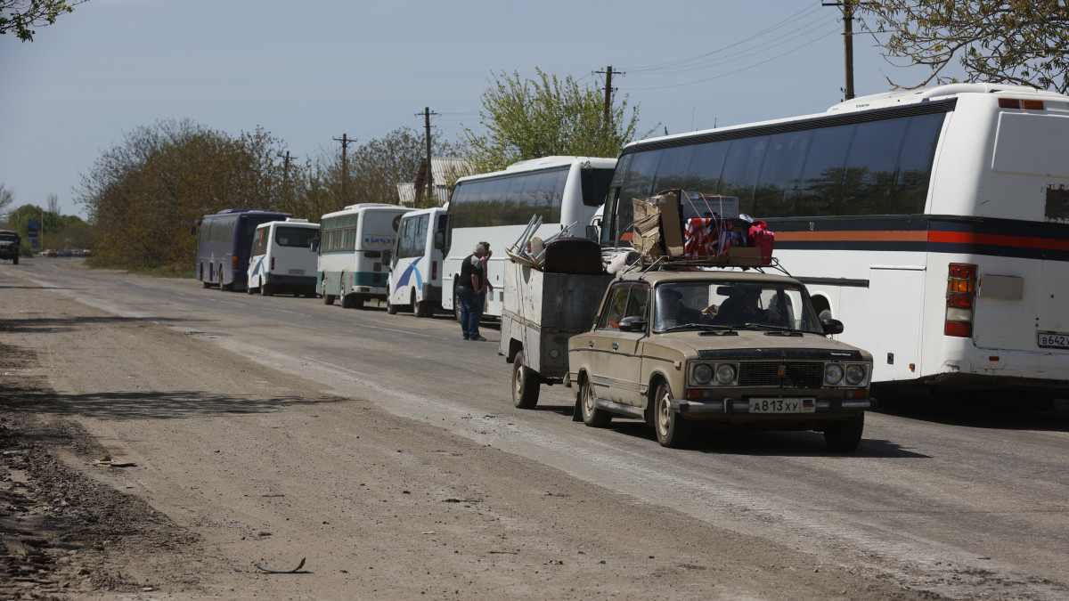 MARIUPOL, UKRAINE - MAY 06: Buses used for evacuation are seen on the road during several dozen Ukrainian civilians, who had been living in the bomb shelters of the Azovstal plant for more than a month, being evacuated in Mariupol, Ukraine on May 06, 2022. The evacuated civilians were taken to a refugee camp in the village of Bezymyannoye. (Photo by Leon Klein/Anadolu Agency via Getty Images)
