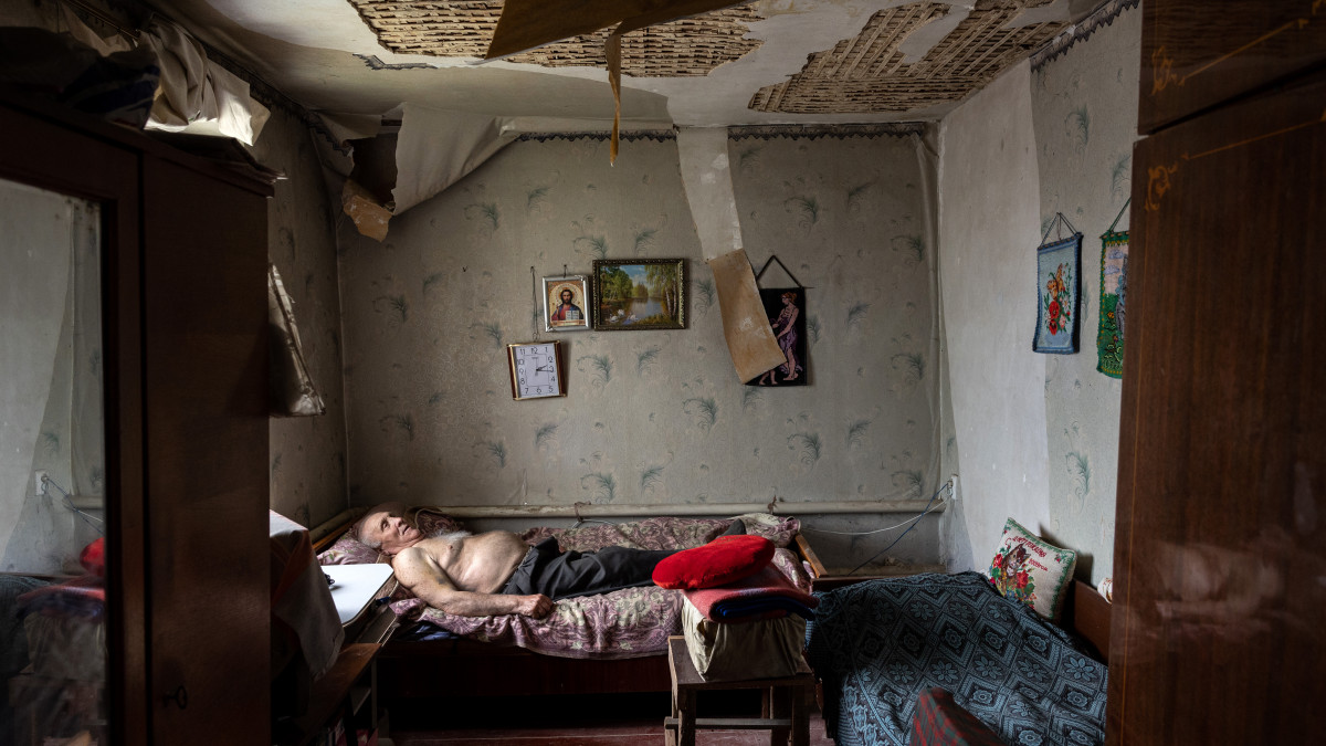VILKHIVKA, UKRAINE- MAY 18: Olexiy Pshenychnykh, 85, rests in his war-damaged home to the east of Kharkiv on May 18, 2022 in Vilkhivka, Ukraine, which had until recently been occupied by Russian forces. Seniors in the city have been relying on humanitarian aid, as their monthly government pension payments were suspended due to the fighting. In recent weeks Ukrainian forces have advanced towards the Russian border after Russias offensive on Kharkiv, Ukraines second largest city stalled. (Photo by John Moore/Getty Images)
