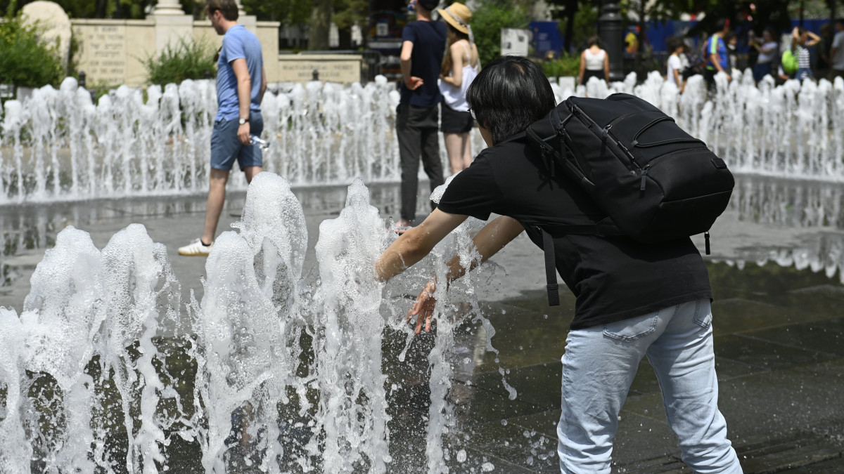 Turista hűsíti magát Budapest belvárosában, a Szabadság téren 2022. július 23-án. A meteorológiai szolgálat előrejelzés szerint ezen a napon tetőzik a kánikula, néhol 40 Celsius-fok felett alakulhat a maximumhőmérséklet.