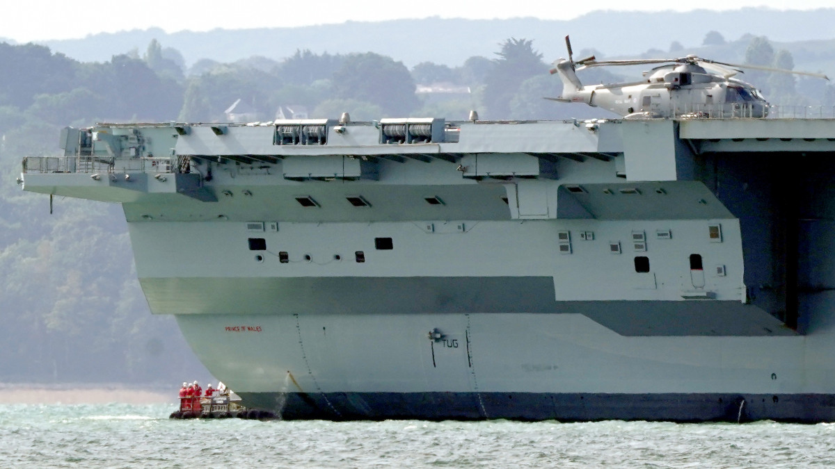 Engineers inspect aircraft carrier HMS Prince of Wales as it sits off the coast of Gosport, Hampshire, after it suffered a propeller shaft malfunction. The GBP 3 billion warship left Portsmouth Naval Base on Saturday before an emerging mechanical issue occurred off the south-east coast of the Isle of Wight. Picture date: Tuesday August 30, 2022. (Photo by Gareth Fuller/PA Images via Getty Images)