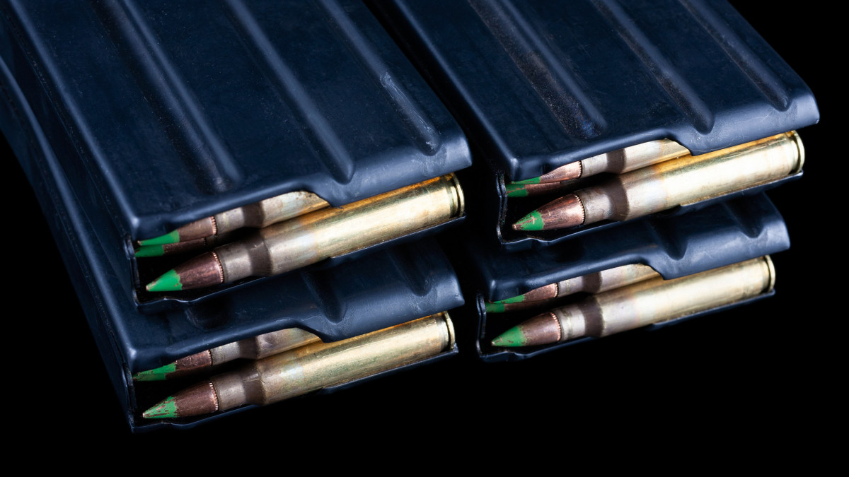 5.56mm NATO ammunition in magazines on black background