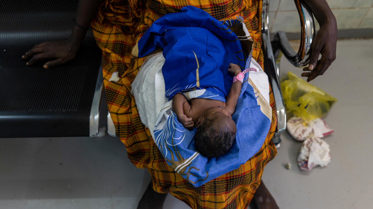On 19 October 2022, a newborn baby lies in its motherâs lap in the neonatal unit at Ondurman Maternity Hospital in Sudan.