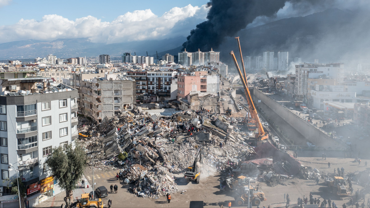 HATAY, TURKIYE - FEBRUARY 07: An aerial view of collapsed buildings after 7.7 and 7.6 magnitude earthquakes hit Hatay, Turkiye on February 7, 2023. Early Monday morning, a strong 7.7 earthquake, centered in the Pazarcik district, jolted Kahramanmaras and strongly shook several provinces, including Gaziantep, Sanliurfa, Diyarbakir, Adana, Adiyaman, Malatya, Osmaniye, Hatay, and Kilis. Later, at 13.24 p.m. (1024GMT), a 7.6 magnitude quake centered in Kahramanmaras Elbistan district struck the region. Turkiye declared 7 days of national mourning after deadly earthquakes in southern provinces. (Photo by Murat Sengul/Anadolu Agency via Getty Images)