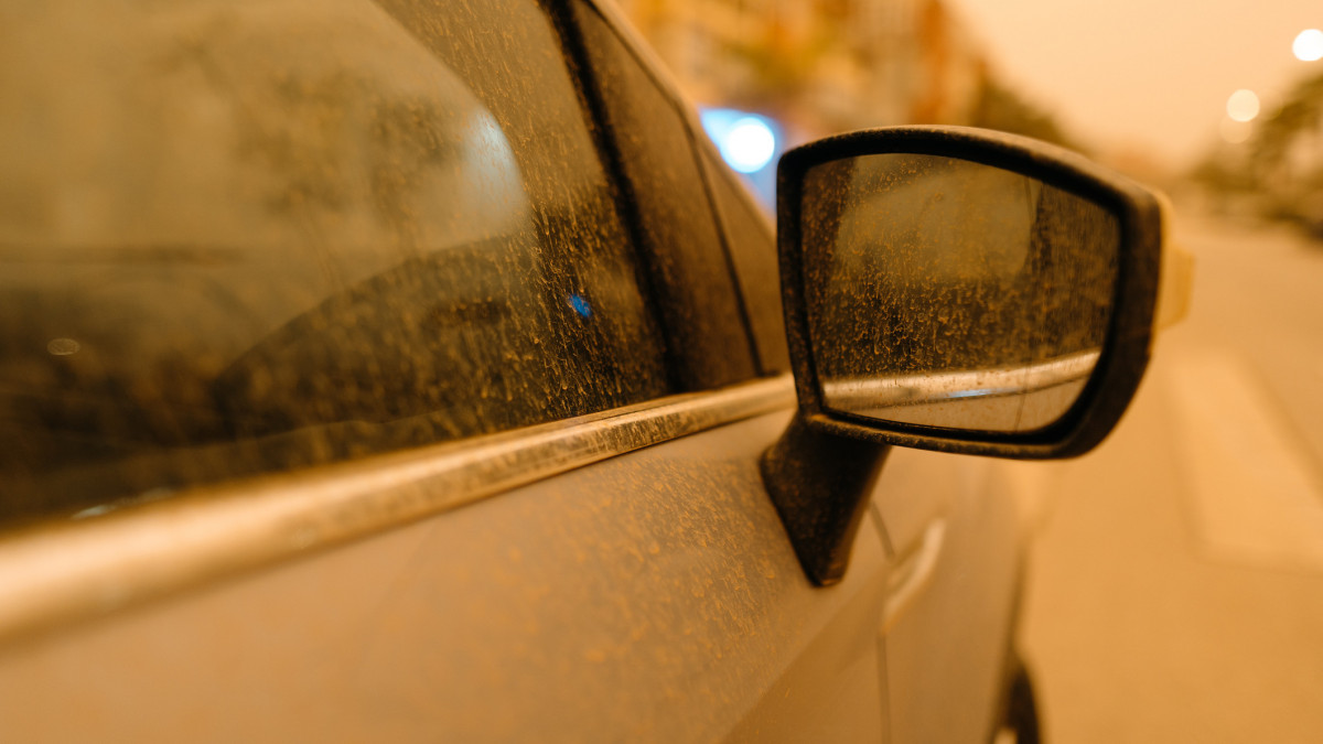 Close up of dirty car by calima. Dust storm from Sahara desert in Torrox Costa, Andalusia