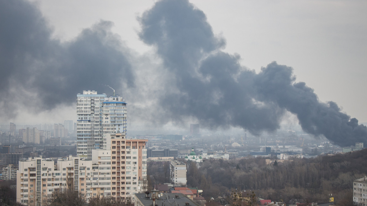Black smoke from explosion in Kyiv, Ukraine. Russian invasion to Ukraine. Missile attack in Kyiv. Kyiv cityscape, view from window. War in Ukraine. Russian agression in Ukraine.