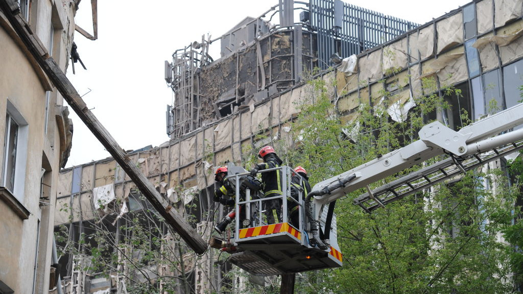 LVIV, UKRAINE - JULY 6: Rescuers in a fire trucks aerial platform dismantle damaged structures of a four-story residential building hit by a missile on July 6, 2023 in Lviv, Ukraine. On the night of July 6, Russian troops attacked Lviv and Oblast with Kalibr missiles, seven of which were destroyed by the Air Defense Forces of Ukraine. One of the missiles hit a four-story residential building, destroying the part of the upper floors and killing at least four residents. (Photo by Mykola Tys/Global Images Ukraine via Getty Images)