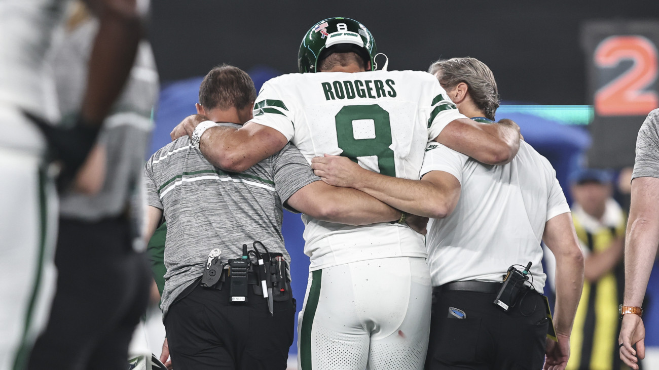 EAST RUTHERFORD, NEW JERSEY - SEPTEMBER 11: Aaron Rodgers #8 of the New York Jets is helped off the field after suffering an apparent injury after being sacked by Leonard Floyd #56 of the Buffalo Bills during a game at MetLife Stadium on September 11, 2023 in East Rutherford, New Jersey. (Photo by Michael Owens/Getty Images)