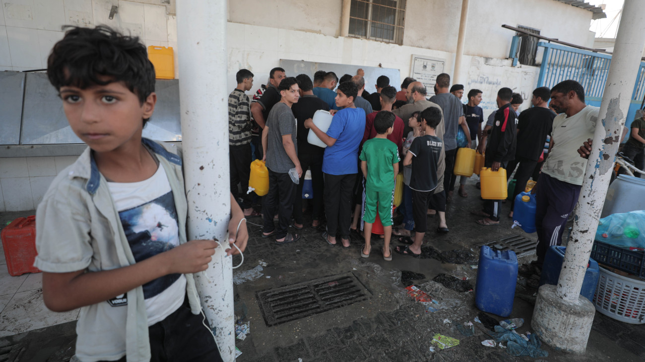 A large number of displaced Palestinians wait in front of a water filling station as they face a water outage in most of Khan Yunis in the southern Gaza Strip, on October 14, 2023. (Photo by Loay Ayyoub/For The Washington Post via Getty Images)